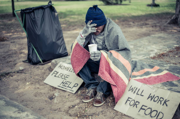istock The beggars sat wrapped in cloths and eating noodles. 1237491347