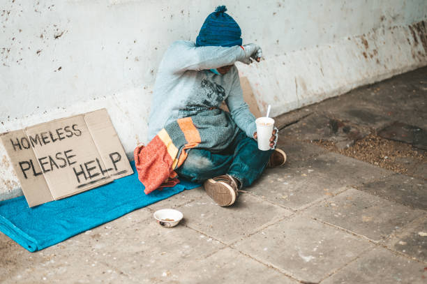 istock The beggars sat wrapped in cloths and eating noodles. 1237492746