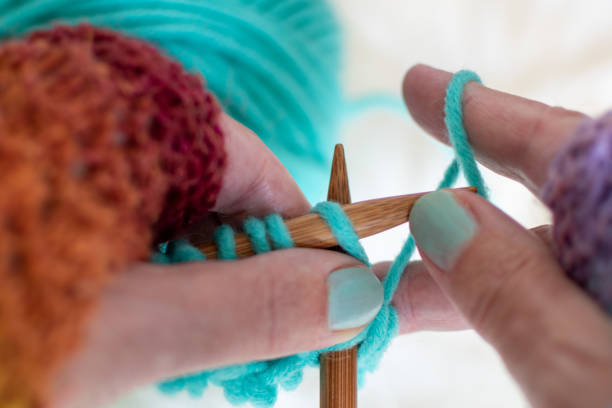 istock Hands knitting with blue yarn and wooden knitting needles 1237497863