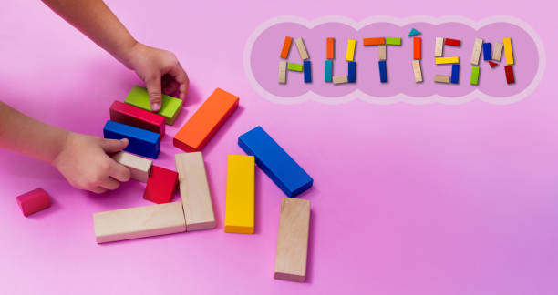 istock A child with an autism spectrum disorder builds a house from a wooden constructor. Concept of autism. 1237506267