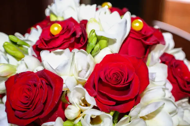 Photo of Bouchet of the bride, made of red roses and white flowers. 50 years of marriage.
