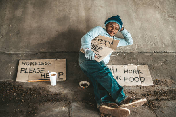 istock Begging under the bridge with a cup containing coins and instant noodles 1237538138