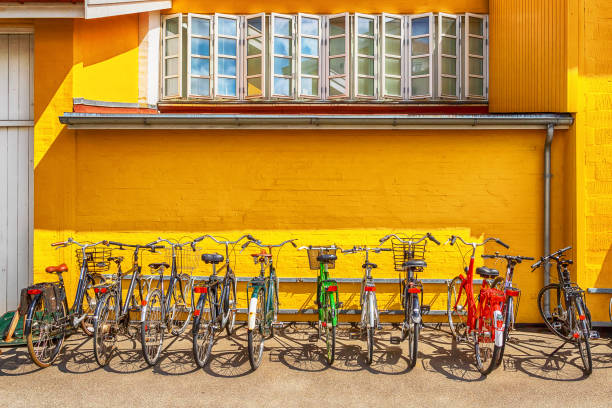 Many bicycles parked in front of a yellow house. Copenhagen. Denmark. Bicycles are one of the main means of transportation .. Many bicycles parked in front of a yellow house. Copenhagen. Denmark. Bicycles are one of the main means of transportation .. Transport. bicycle rack photos stock pictures, royalty-free photos & images