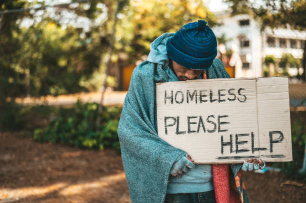 istock Beggars stand on the street with homeless messages please help. 1237543371