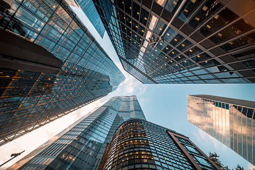 Highly detailed abstract wide angle view up towards the sky in the financial district of London City and its ultra modern contemporary buildings with unique architecture. Shot on Canon EOS R full frame with prime 10mm extreme wide angle lens. Image is ideal for background.