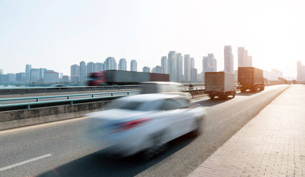 istock Trucks and car speeding on city viaduct 1237548136
