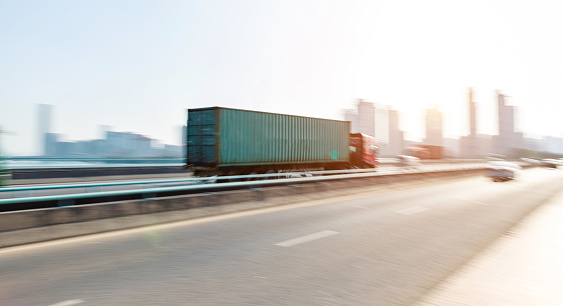 Truck speeding on city viaduct.