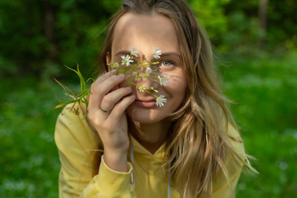 istock Woman sniffs wildflowers. Calmness and unity with nature 1237568526