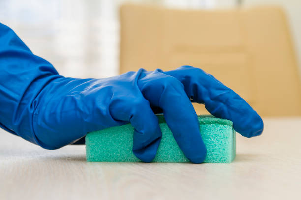 istock A human hand in a protective glove disinfects the table with a sponge for viruses prevention 1237573829