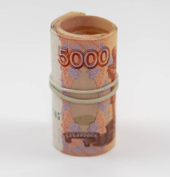 istock Banknotes five thousand rubles 5000 in a roll with an elastic band. Russian currency to save. Close-up, white background. The concept of the safety of deposits and money. 1237583955