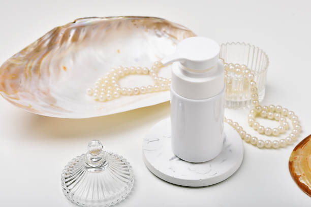 istock Cosmetic bottle containers with marine pearl extraction essence, Blank label for organic branding mock-up, Natural skincare beauty product concept. 1237596236