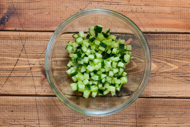istock Step-by-step preparation of salad with salted salmon, fresh cucumbers and herbs, step 2 - chopped fresh cucumber, top view, selective focus 1237599892