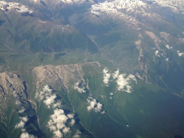 istock mountains and clouds from the plane window. mobile photo 1237630556
