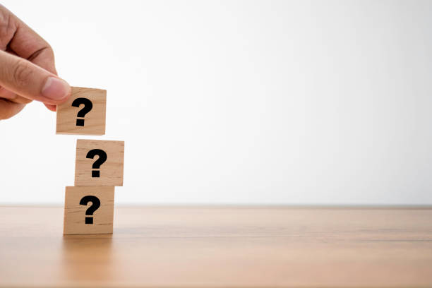istock Hand putting question mark print screen on wooden cubes for Q&A or question and answer. Training Meeting and discussion concept. 1237644605