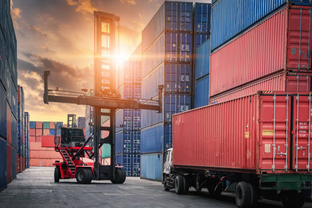 istock Container Cargo Port Ship Yard Storage of Logistic Transportation Industry. Forklift is Stacking Containers of Freight Import/Export Shipment. Business Shipping Logistics Service Transport Industrial 1237645797