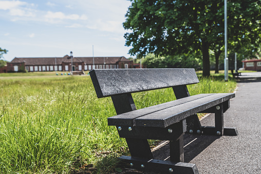 Park bench in a public park closed during lockdown.  Selective focus.  Belfast, Northern Ireland.