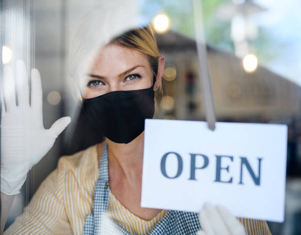 istock Coffee shop woman owner with face mask, open after lockdown quarantine. 1237664181