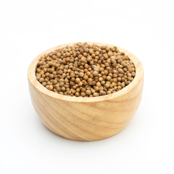 istock dried coriander seeds wooden bowl on white background 1237676889