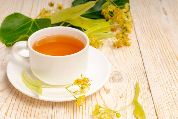 istock white tea cup with linden flowers on wooden table 1237682240
