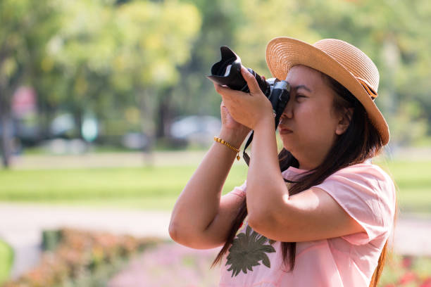 istock Beautiful Asian women with backpack aim camera in the jungle 1237691814