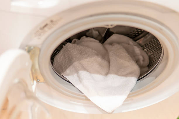 istock The washing hatch. Washing machine, white for laundry with white terry towel 1237696543