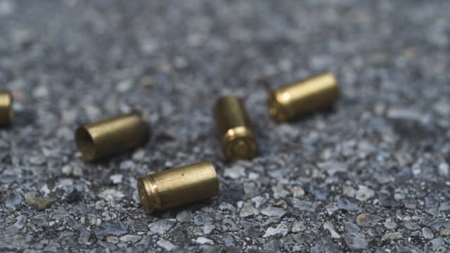 Bullet casings on asphalt