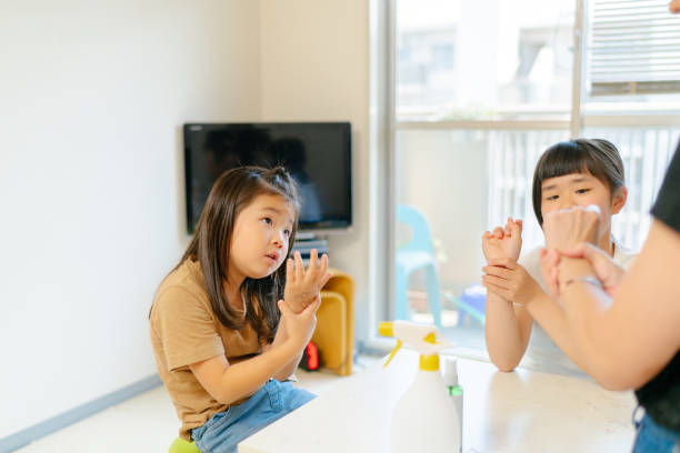 istock Mother teaching her daughters how to wash hands properly 1237701867