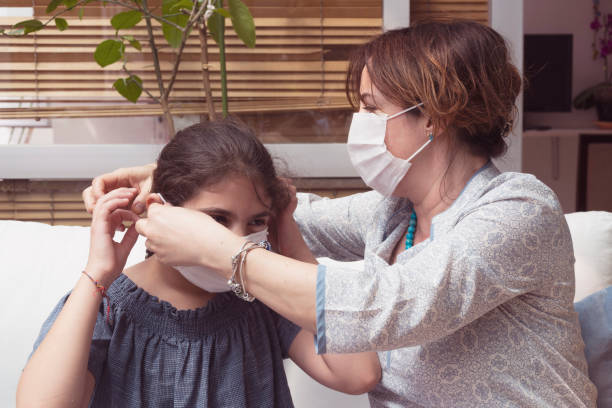 istock Protective mask weared family at balcony and smiling. 1237707851