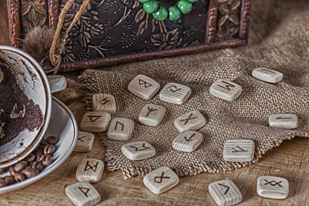 istock Isoteric concept of divination and prediction. Runes, coffee grounds in a cup, rosary on a table against the background of an old chest 1237708398