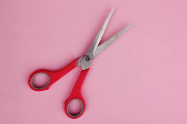 istock one pair of scissors with pink handles on a pink bed background 1237712127