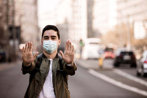 istock Man with a mask gesturing stop. They found the coronavirus vaccine! 1237725467
