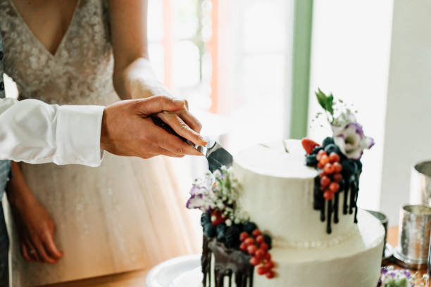 istock photo of a couple cutting a wedding cake 1237783274
