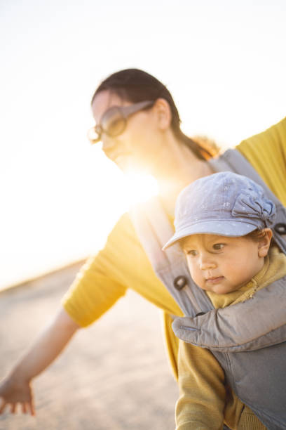istock Young mother walking on the beach with her baby daughter 1237784321