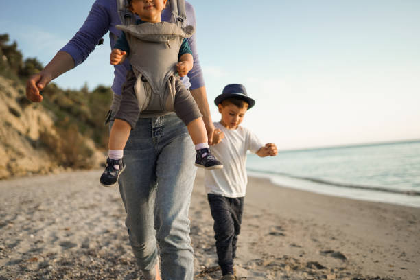 istock Young mother walking on the beach with her children 1237789632