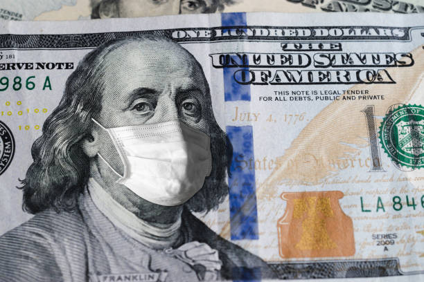 istock One Hundred US.Dollar bill with medical mask safety covid-19 on 2020. 1237808747