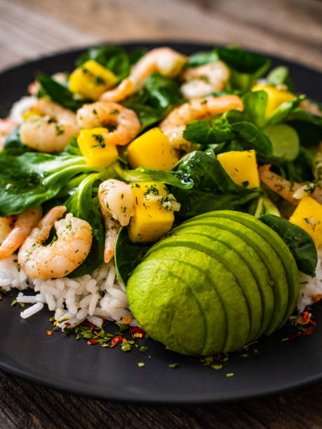 istock Prawns with vegetables on wooden table 1237824754