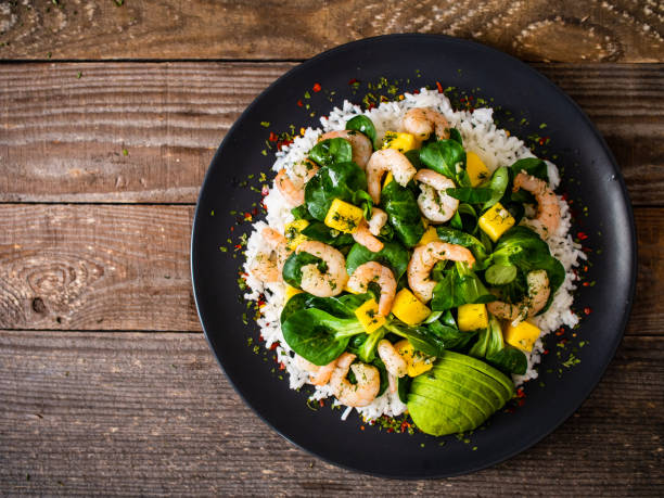 istock Prawns with vegetables on wooden table 1237825290