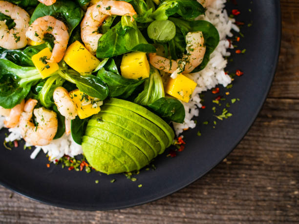 istock Prawns with vegetables on wooden table 1237825836