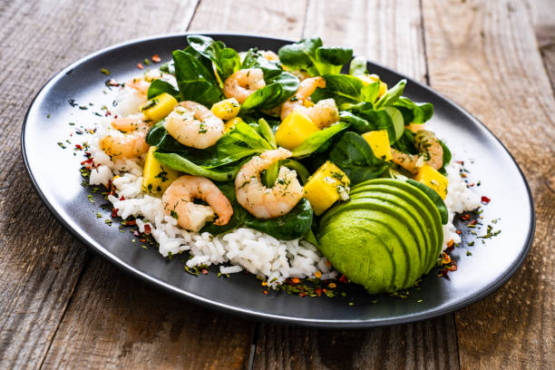 istock Prawns with vegetables on wooden table 1237827415