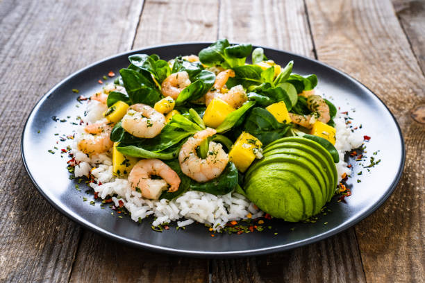 istock Prawns with vegetables on wooden table 1237827962