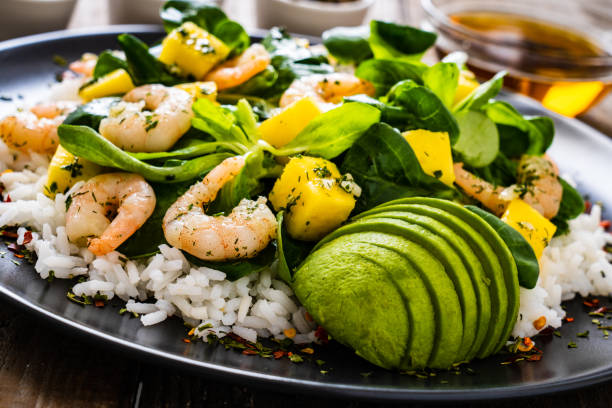 istock Prawns with vegetables on wooden table 1237828360