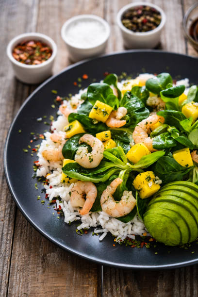 istock Prawns with vegetables on wooden table 1237829081