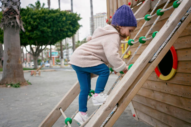 Three years old child having fun in a playground