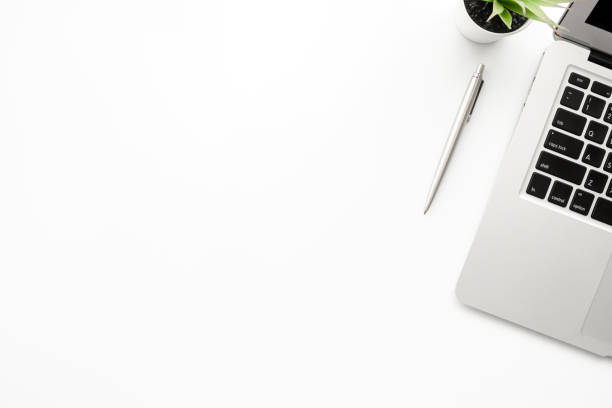 istock White office desk table with laptop computer and pen. Top view with copy space, flat lay. 1237845383