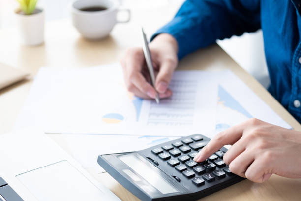 istock Businessman is inspecting and checking the business reports graphs to audit the financial reports by calculating the results. Analyzing the revenue and auditing the budget concept. 1237846462