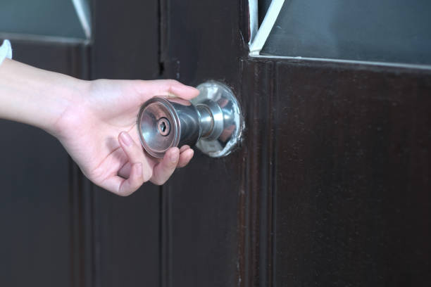 istock A girl open doorknob to the house 1237851640