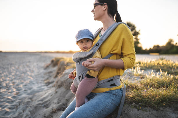 istock Young mother sitting with her daughter on the beach 1237853730