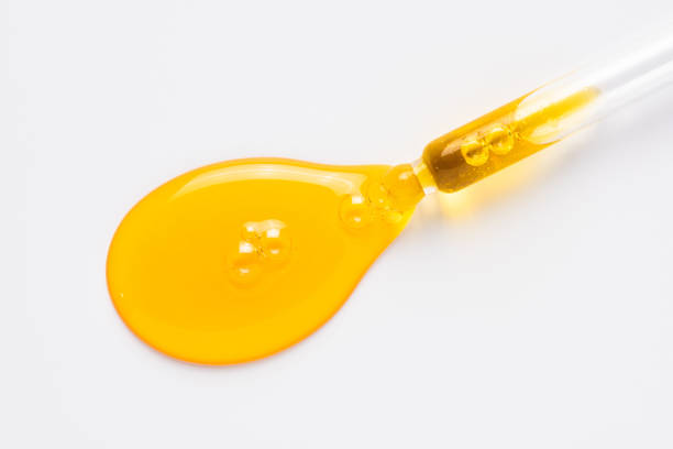 istock Cosmetic dropper with yellow oil. Anti-aging serum on white. 1237860108