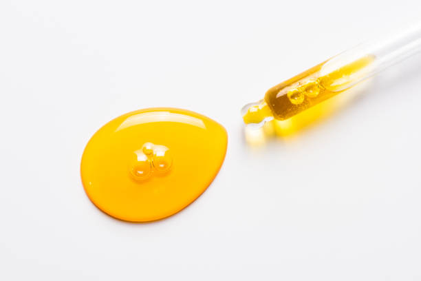 istock Cosmetic dropper with yellow oil. Anti-aging serum on white. 1237860120