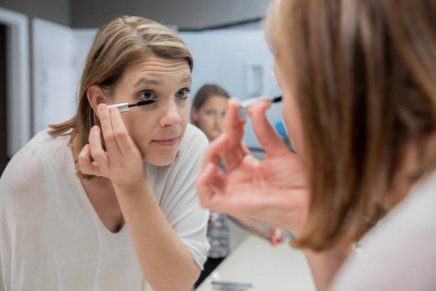 istock Adult woman applying mascara to eyelashes 1237894700